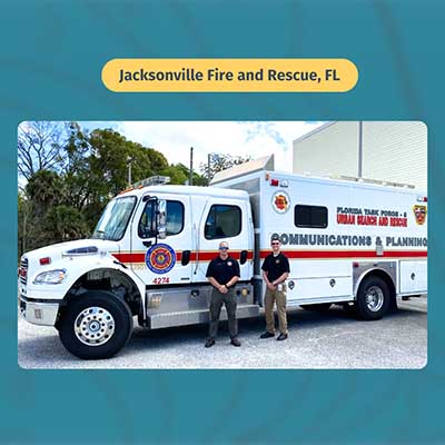 Two men by a Jacksonville Fire and Rescue mobile command truck.