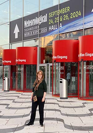 Martha in front of the Met Tech 2024 building in Vienna