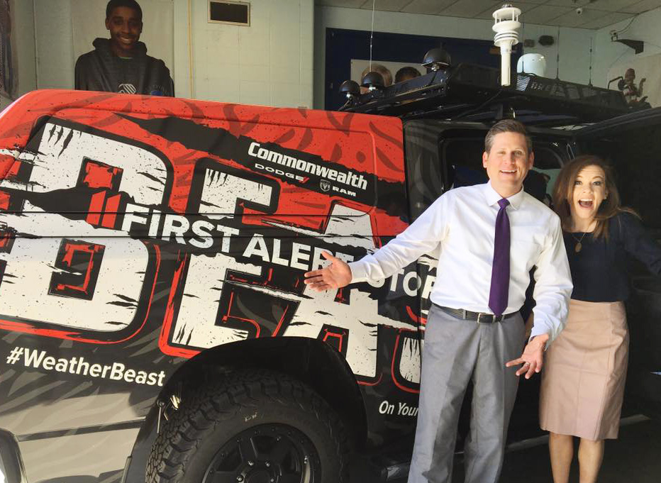 WHAS11 Meteorologists pose by the "Weather Beast" vehicle